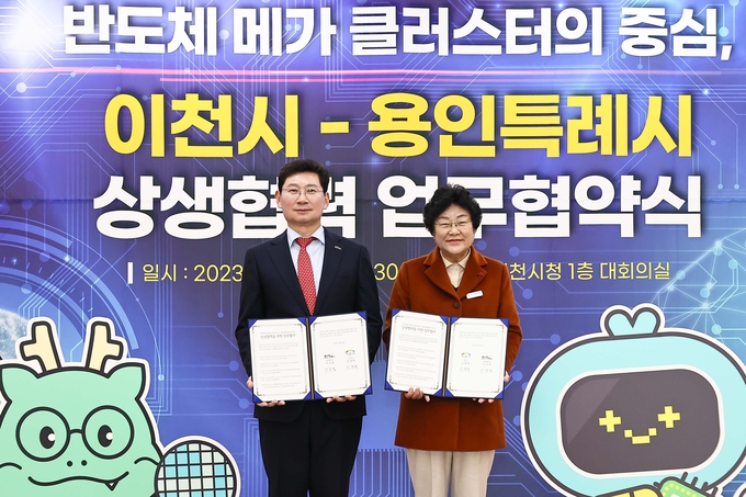 <strong>용인특례시-이천시 반도체산업 상생협력 업무협약 체결 후 기념사진을 찍고 있는 이상일 용인특례시장(왼쪽)과 김경희 이천시장(오른쪽)</strong>