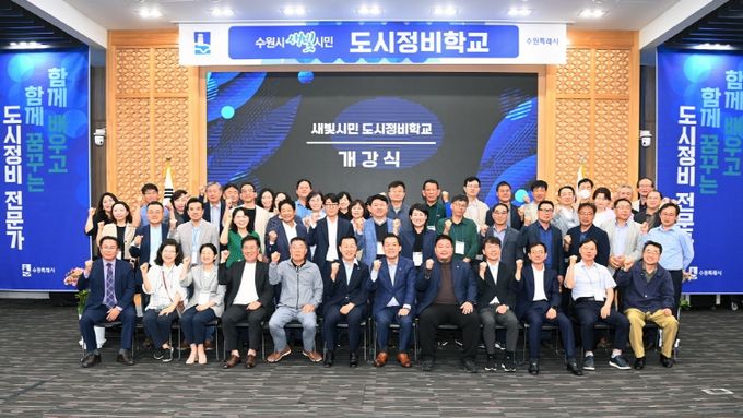 <strong>수원시가 도시정비를 주민 중심으로 추진하기 위해 도시정비 전문가를 양성하는 도시정비학교 개강식에서 참석자들이 기념촬영을 하고 있다.</strong>